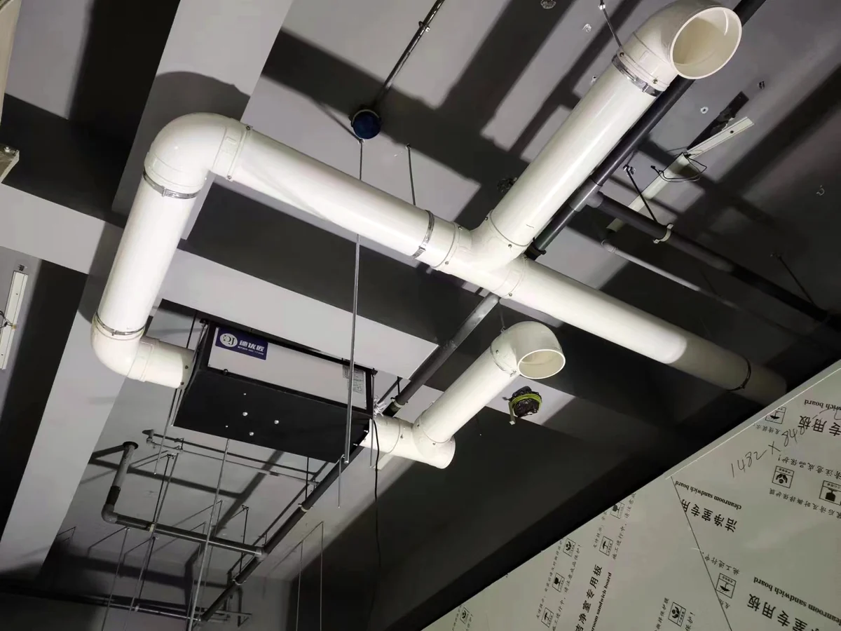 Ceiling ducted dehumidifier connected to supply and return air ducts